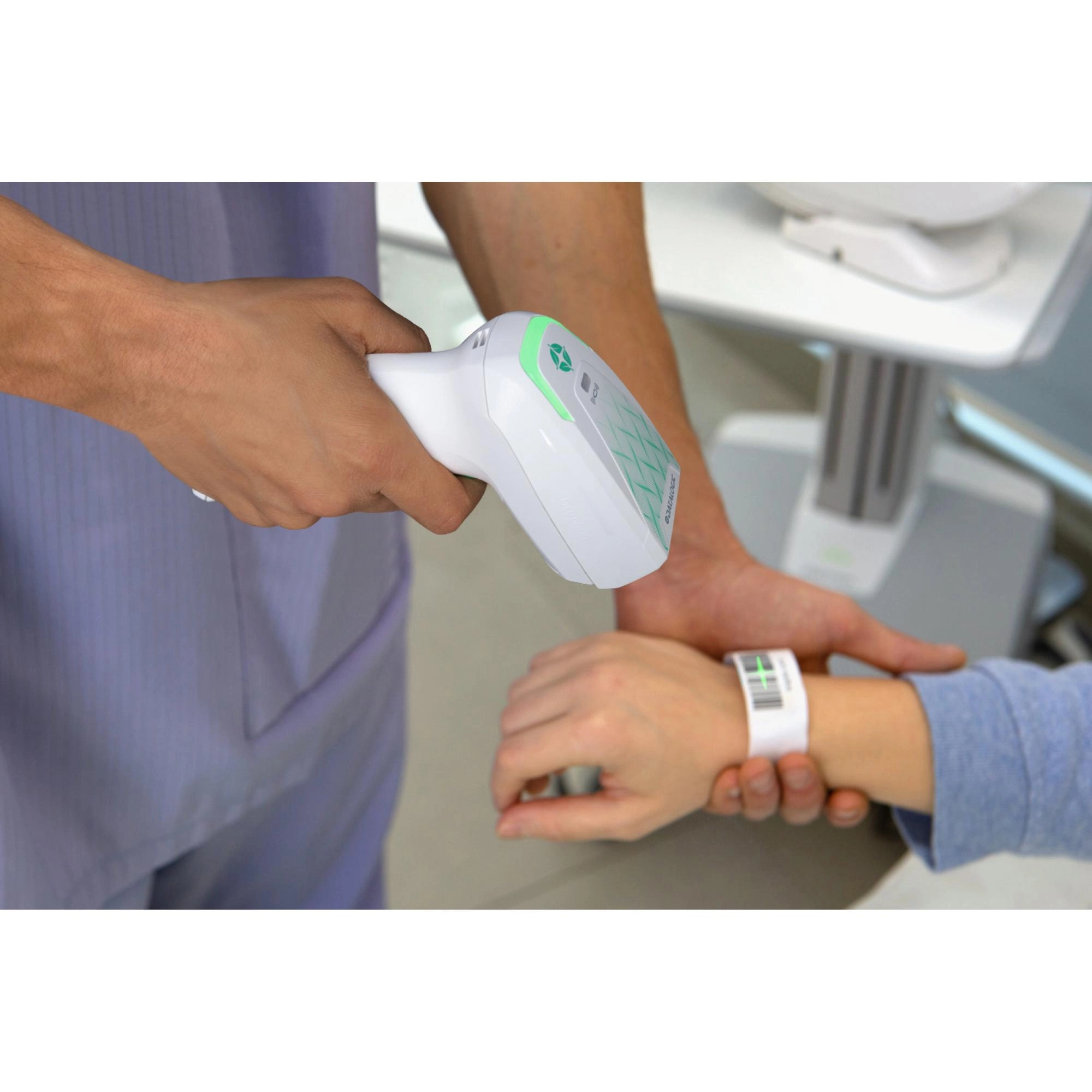 Datalogic Gryphon GM4600 HC wireless 1D/2D healthcare barcode scanner scanning a patient wristband, with hygienic white IP52 housing and USB kit