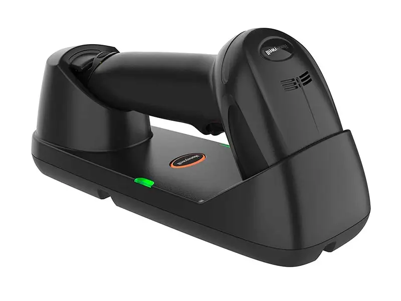 Schwarzer Funk-Barcodescanner in Ladestation auf Tisch