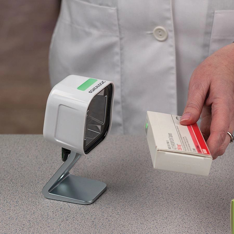 Datalogic Magellan 1500i USB presentation scanner reading a product barcode at a POS counter, ideal for fast 1D/2D barcode and mobile coupon scanning